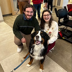 Aaron Hitchcock and fellow student with a therapy dog.