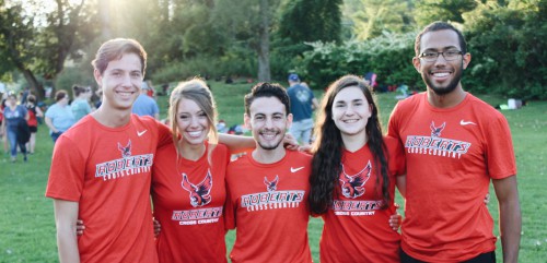 Addie and four teammates wear red Roberts gear and smile