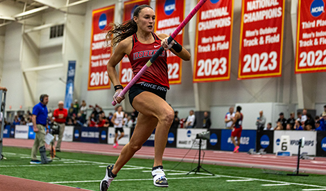 Brynn runs while holding pole in run up.