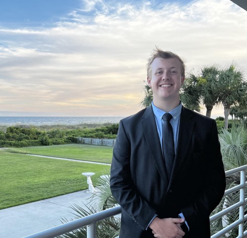 Devan Levan smiles in front of sunset