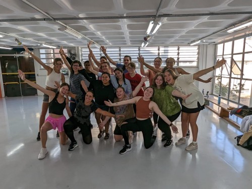 Students pose and smile at samba class