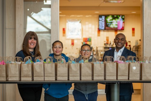 The 4 Hayles family members - Maryann, Savannah, Stephen, and Dr. Rupert A. Hayles Jr. - stand and smile behind bags they gave out for Easter.