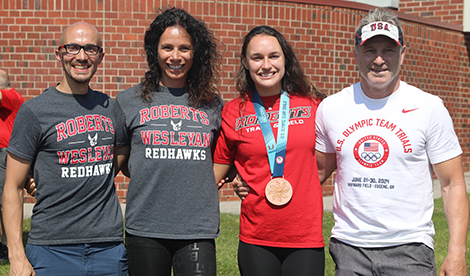 Brynn King smiles with coaches