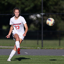 Jenna Northrup kicks soccer ball