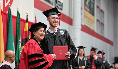 Joe Otto recieves his diploma at graduation.