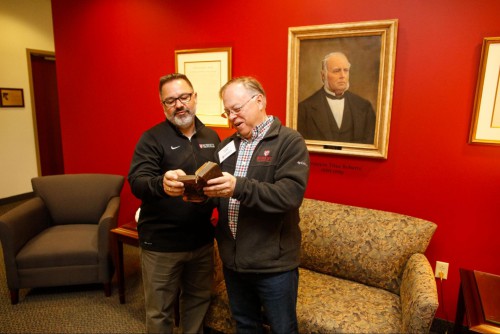 Kirk and Douglas Hallett look at Bible together while standing