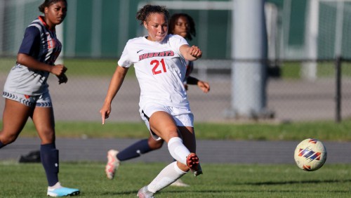 Larissa Johnston kicks the soccer ball during a game.