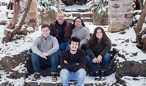 Lisa and her family smile outside.