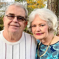 Nancy Rathke and her husband smile.