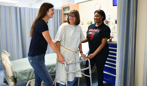 2 students work with a patient