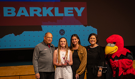 Paige Barkley, young woman, Bob Segave, President Porterfield, and Reggie