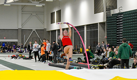 A young woman makes a pole vault attempt