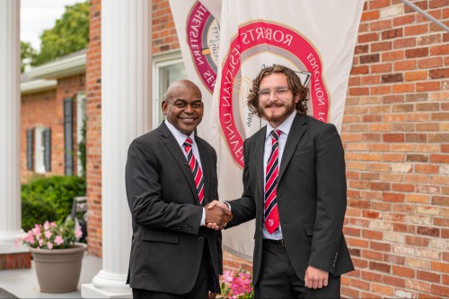 President Hayles smiles with Aaron Hitchcock.