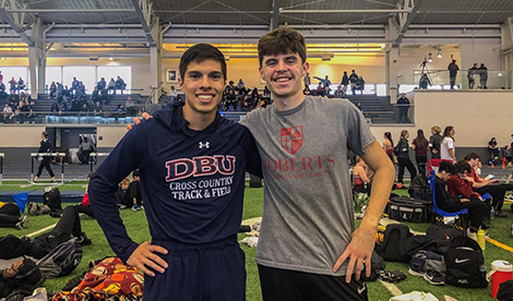 Angel Luera and Ryan Karker smile at a track meet.