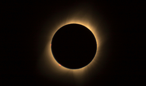 The sun is blocked by the moon. A ring of light from the sun is visible surrounding the moon.