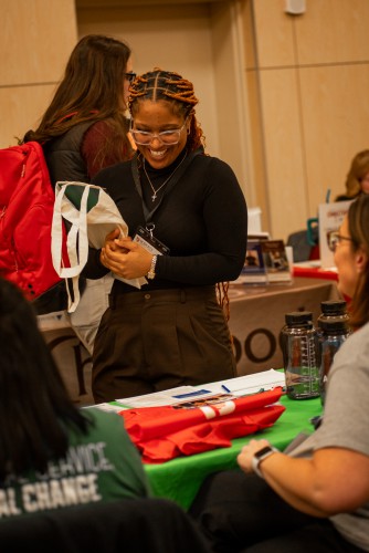 A student smiles at a career fair.