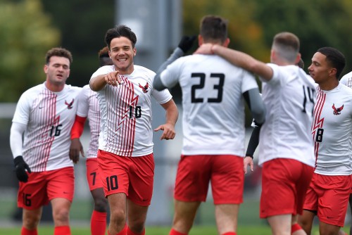 Tamas Nagy celebrates with teammates during a soccer game.