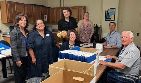 Lisa DeVinney (second from the left) with Mary Cariola staff, including Karen Zandi (CEO, far left) and Erin DiCesare (Director of Learning & Organizational Development (sitting, third from the left).