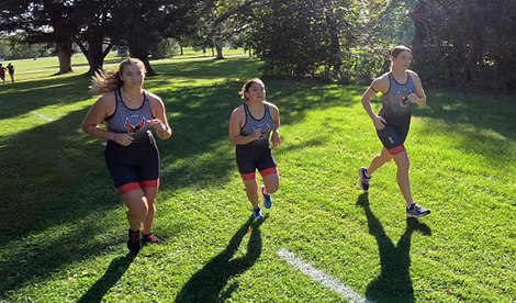 3 Roberts triathlon athletes run during a race.