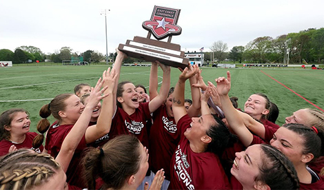 The Roberts women's lacrosse team celebrates their ECC championship win