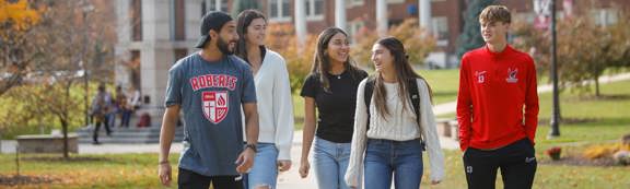 5 students walk across campus